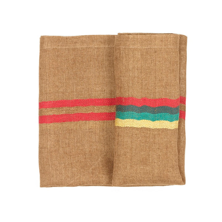This folded open weave napkin is modish and soft to the touch. Ginger-colored ground with stripes in red, blue, green and mustard, Yukon is a stylish napkin that beautifies your table setting and culinary design splendidly.  From rustic European country style to modern high design, the high art of the textile brings out sensations of joy and comfort.