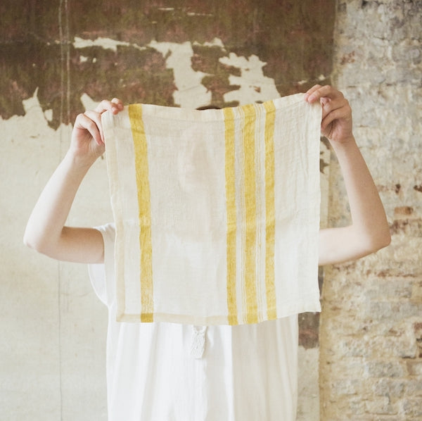 Libeco Belgian linen table cloth napkin with soft mustard color stripes called The Library Stripe