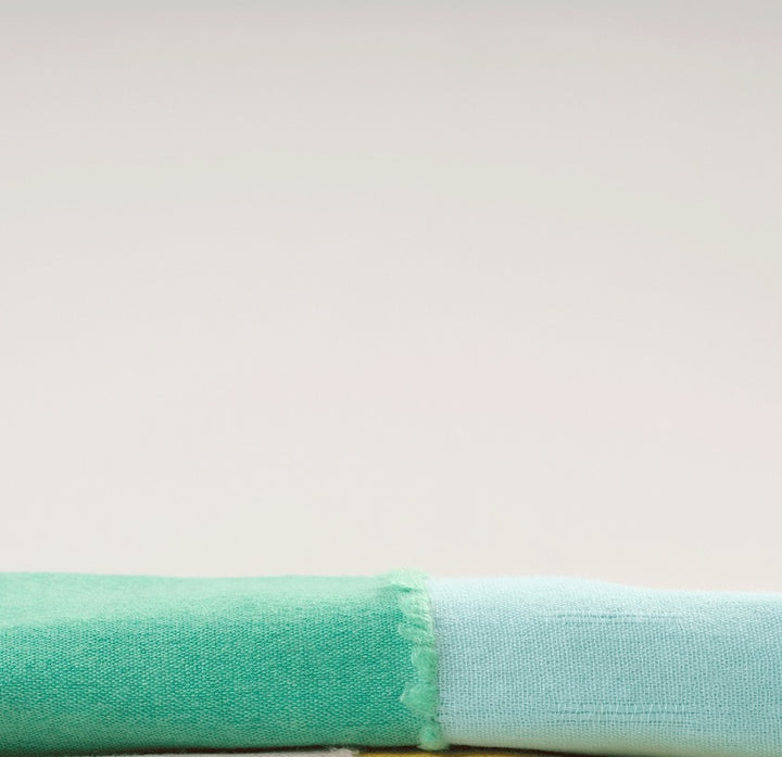 Finest Italian cashmere shawl, Plyuia in Turquoise color is the result of a collaboration with Helena Rohner. The supremely lightweight cashmere and vibrant colors