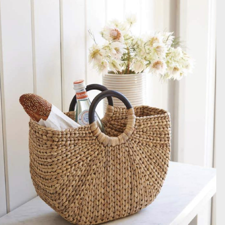 Woven basket tote made of hyacinth, with a half moon shaped ebonized wooden handles